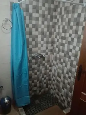 a shower with a blue curtain in a bathroom at Casa 100m2 in Chiclana de la Frontera