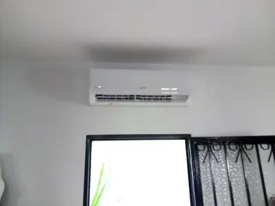 a ceiling fan in a room with a window at Casa 100m2 in Chiclana de la Frontera