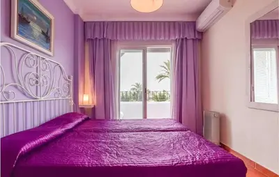 a purple bedroom with a large bed with a window at Charming Apartment in Rota with Garden and Lake Views, 81 m² in Rota