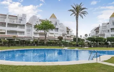 a swimming pool in front of some apartment buildings at Charming Apartment in Rota with Garden and Lake Views, 81 m² in Rota