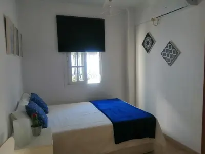 a white bedroom with a bed and a window at Room in Lovely cottage house Habitaciones en Chalet en Cadiz San Fernando in San Fernando