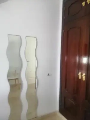 a room with two vases on the wall next to a door at Room in Lovely cottage house Habitaciones en Chalet en Cadiz San Fernando in San Fernando