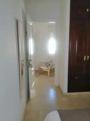 a hallway with a door and a chair in a room at Room in Lovely cottage house Habitaciones en Chalet en Cadiz San Fernando in San Fernando