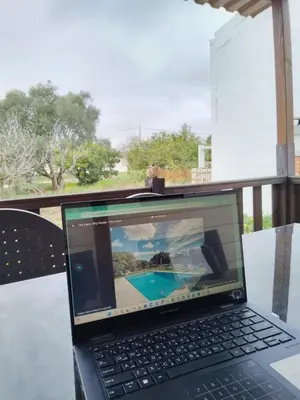 a laptop computer sitting on top of a table at The Farm Tiny House - Tiny Casa in Chiclana de la Frontera
