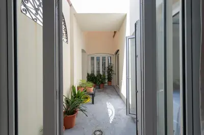 a corridor of a building with potted plants at Apartamentos Homing Puerto Sherry in El Puerto de Santa María