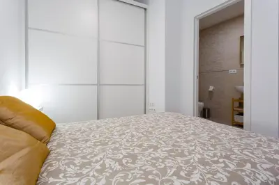 a bedroom with a large bed with a white bedspread at SH Precioso Cruz. Acogedor y cerca del Mercado in Cádiz
