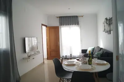 a living room with a table with chairs and a couch at CDZ - Ático Tavira in Cádiz