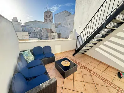 a living room with blue chairs and a table at CDZ - Ático Tavira in Cádiz