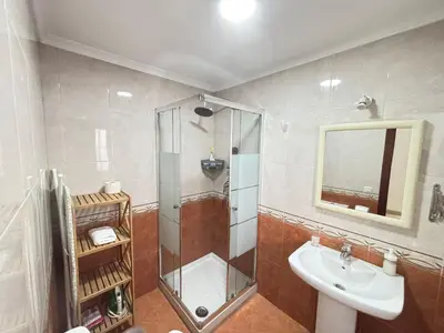 a bathroom with a shower and a sink and a mirror at CDZ - Ático Tavira in Cádiz