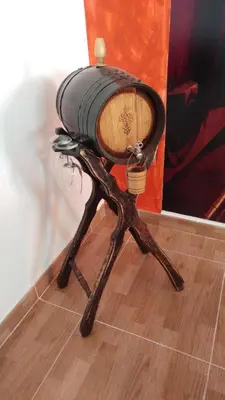 a wooden chair with a barrel on the floor at Apartamento Jerez Centro in Jerez de la Frontera
