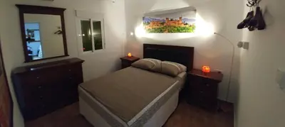 a small bedroom with a bed and a mirror at Apartamento Jerez Centro in Jerez de la Frontera