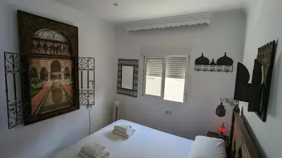a bedroom with a bed and a picture on the wall at Apartamento Jerez Centro in Jerez de la Frontera
