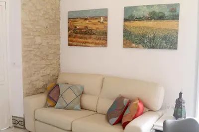 a living room with a couch and two paintings on the wall at Casa Atahona - Casita con Encanto in Medina Sidonia