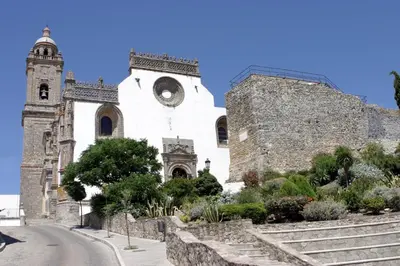 a church with a clock on the side of it at Casa Atahona - Casita con Encanto in Medina Sidonia