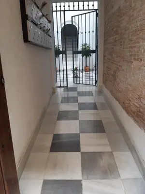 a hallway with a black and white checkered floor at El Rincón del Tío de la Tiza in Cádiz