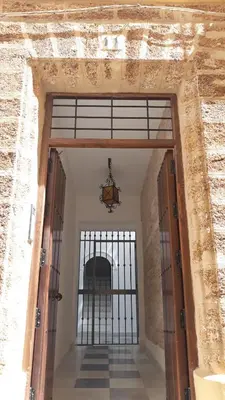 an entrance to a building with an open door at El Rincón del Tío de la Tiza in Cádiz