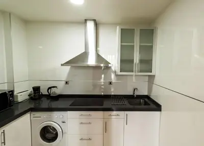 a kitchen with a sink and a stove at Casa Comillas - Apartamento Doble in Cádiz