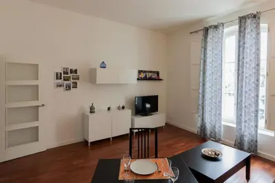 a living room with a table and a tv at Casa Comillas - Apartamento Doble in Cádiz