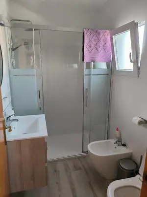 a bathroom with a shower and a sink and a toilet at Villa Coral in Chiclana de la Frontera