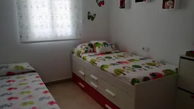 a childs bedroom with a bed and a window at Apartamento Playa de Punta Candor in Rota
