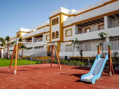 a playground in front of a building at Apartamento Playa de Punta Candor in Rota