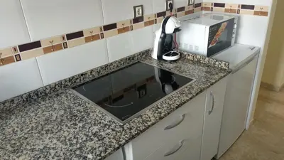 a kitchen counter with a sink and a microwave at ARBOLÍ DREAMS in Cádiz