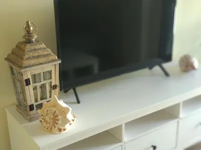a table with a television and a small house on it at ARBOLÍ DREAMS in Cádiz