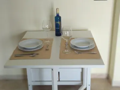 a white table with plates and wine glasses on it at ARBOLÍ DREAMS in Cádiz