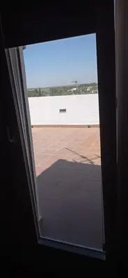 an open door with a view of a patio at La Luciérnaga in Chiclana de la Frontera