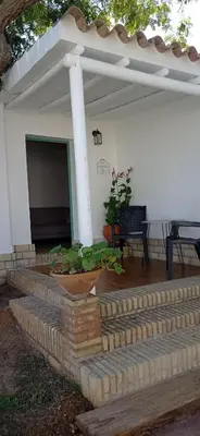 a patio with steps leading to a white building with at La Luciérnaga in Chiclana de la Frontera