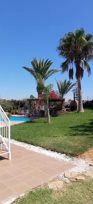 a resort with palm trees and a swimming pool at La Luciérnaga in Chiclana de la Frontera