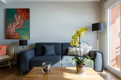 a living room with a blue couch and a table at ALTAMAR Sunny Home by Cadiz4Rentals in Cádiz