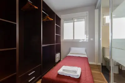 a small bedroom with a red bed and a window at ALTAMAR Sunny Home by Cadiz4Rentals in Cádiz