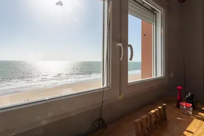 a room with a window with a view of the beach at ALTAMAR Sunny Home by Cadiz4Rentals in Cádiz