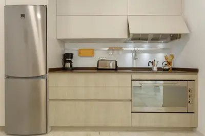 a kitchen with a stainless steel refrigerator at Apartamento La Pepa de ORO by Cadiz4Rentals in Cádiz