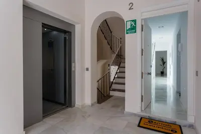 a hallway with a mirror and stairs in a house at Apartamento La Pepa de ORO by Cadiz4Rentals in Cádiz