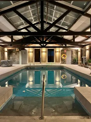 a swimming pool in a building with a ceiling at El Caseron de Conil & Spa in Conil de la Frontera