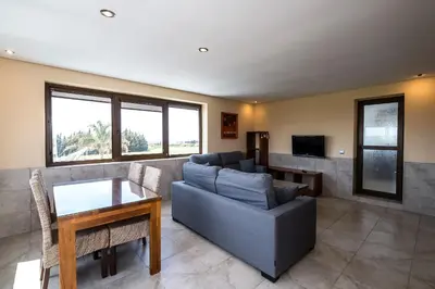 a bedroom with a yellow bed and a mirror at El Caseron de Conil & Spa in Conil de la Frontera