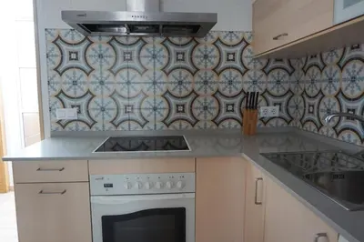 a kitchen with a stove top oven next to a sink at Adosado en playa de la Barrosa, casa Carlota in Chiclana de la Frontera