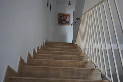 a staircase in a house with wooden floors at Adosado en playa de la Barrosa, casa Carlota in Chiclana de la Frontera