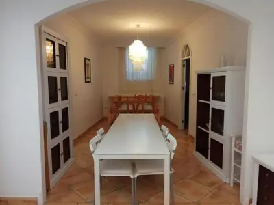a dining room with a white table and chairs at Casa GaLuz, entre la Sierra y el Mar in Alcalá de los Gazules