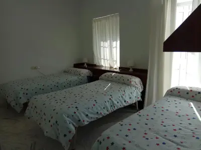 a bedroom with two beds with polka dot sheets at Casa GaLuz, entre la Sierra y el Mar in Alcalá de los Gazules