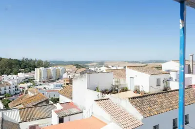 a view of a city with roofs and buildings at Casa GaLuz, entre la Sierra y el Mar in Alcalá de los Gazules