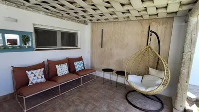 a living room with a couch and a swing at MODERNO LUJO in Novo Sancti Petri