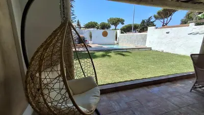 a hammock hanging from a room with a yard at MODERNO LUJO in Novo Sancti Petri