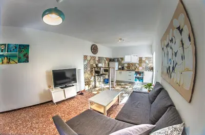 a living room with a couch and a tv at Casa Venice in Chiclana de la Frontera