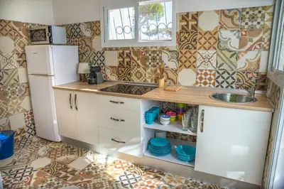 a small kitchen with a sink and a refrigerator at Casa Venice in Chiclana de la Frontera