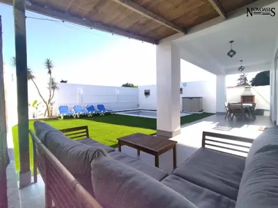 a living room with a couch and a yard at Novoasis in Chiclana de la Frontera
