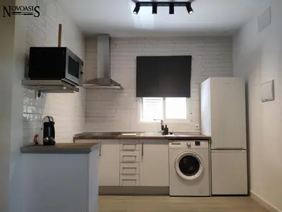 a kitchen with a refrigerator and a washing machine at Novoasis in Chiclana de la Frontera
