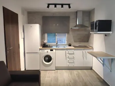 a kitchen with a refrigerator and a washing machine at Novoasis in Chiclana de la Frontera